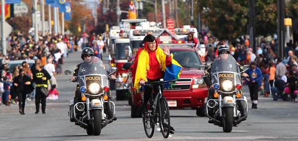 Newark Mayor Polly Sierer leads Newark's Halloween Parade on a bike.